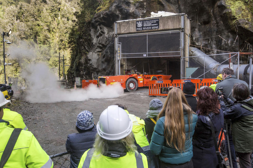 In this image released by the Pike River Recovery Agency, families watch as a loader enters the Pike River Mine, near Greymouth on the West Coast of New Zealand, Tuesday, May 21, 2019. Crews in New Zealand on Tuesday reentered an underground coal mine where a methane explosion killed 29 workers more than eight years ago, raising hopes among family members that they might find bodies and new evidence that leads to criminal charges. (Neil Silverwood/Pike River Recovery Agency via AP)