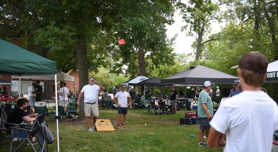 Tailgaters play games Friday, Sept. 2, 2022, before the season opener at Spartan Stadium in East Lansing against Western Michigan.