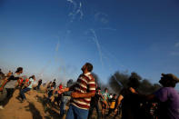 Tear gas canisters are fired by Israeli troops towards Palestinian demonstrators during a protest demanding the right to return to their homeland at the Israel-Gaza border, in Gaza August 17, 2018. REUTERS/Mohammed Salem