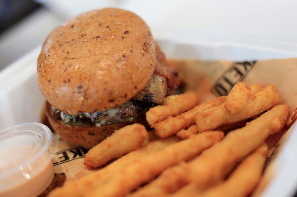 A black and blue burger is shown with keto fries Wednesday, Jan. 17, 2024 at PangeaKeto at Beach Boulevard and San Pablo Road in Jacksonville, Fla. The ketogenic franchise eatery and grocery store focuses on healthy options such as sugar and gluten-free meals and snacks. [Corey Perrine/Florida Times-Union]