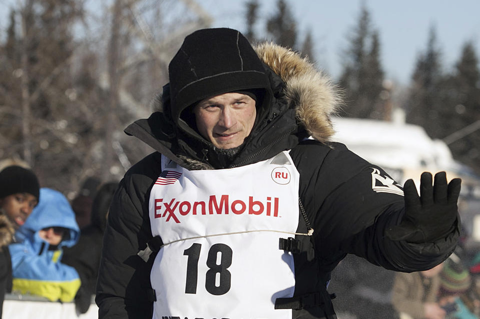 FILE - Dallas Seavey (18) waves at the start of an Iditarod Trail Sled Dog Race in Fairbanks, Alaska, March 6, 2017. Seavey overcame killing a moose and receiving a time penalty to win the Iditarod on Tuesday, March 12, 2024, a record-breaking sixth championship in the world’s most famous sled dog race. (AP Photo/Ellamarie Quimby, File)