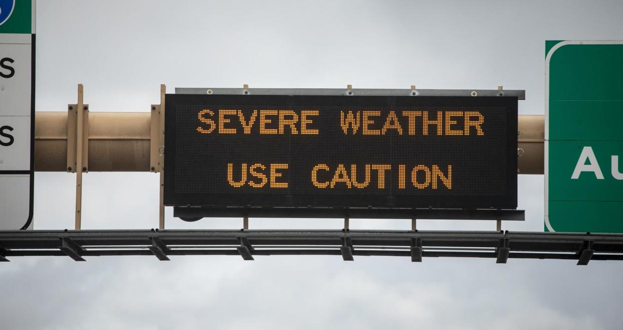 Digital sign at freeway stating Severe Weather Use Caution with wet freeway and traffic. The image is from the 15 freeway in San Diego County California