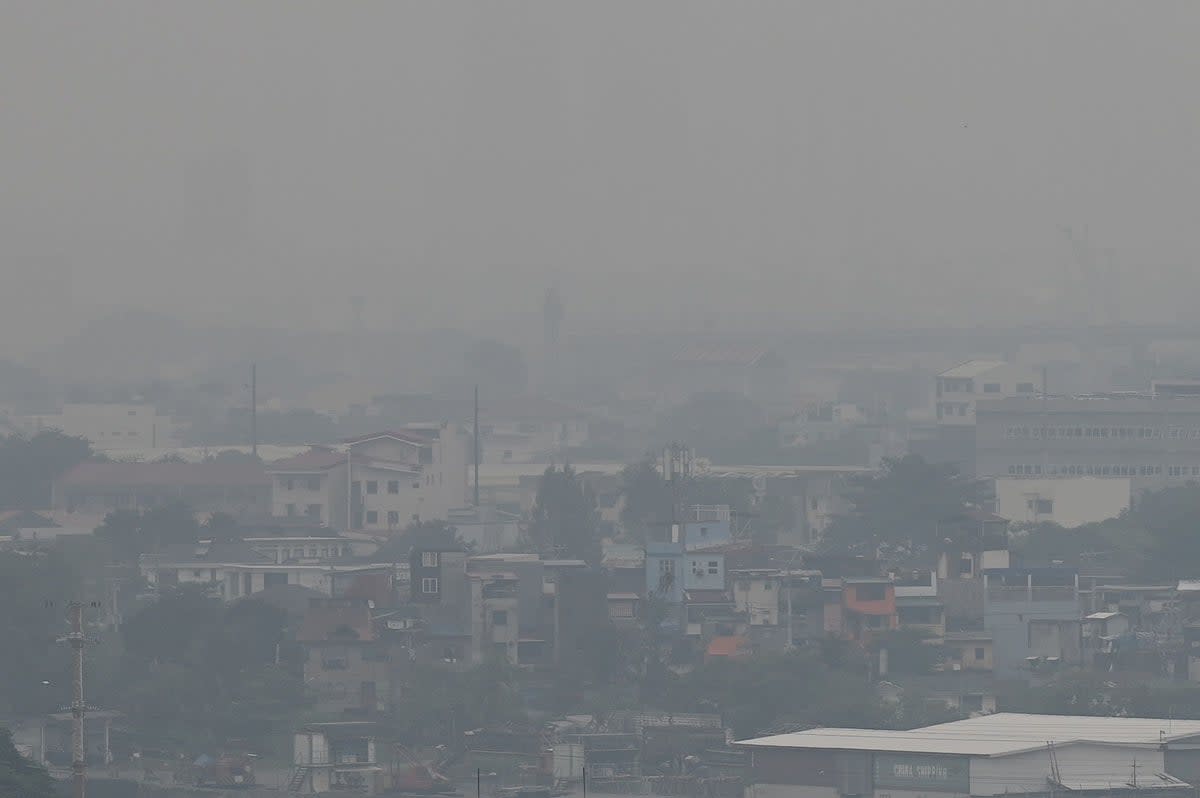 The Manila skyline is seen shrouded in smog (AFP via Getty Images)