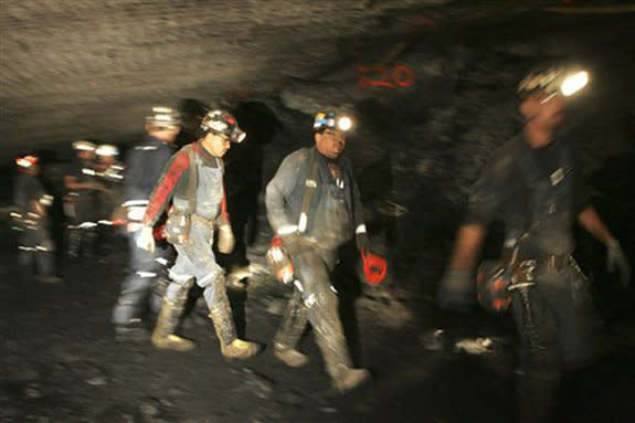 Rescuers work near the blocked tunnel in Utah's Crandall Canyon mine where six coal miners are trapped.