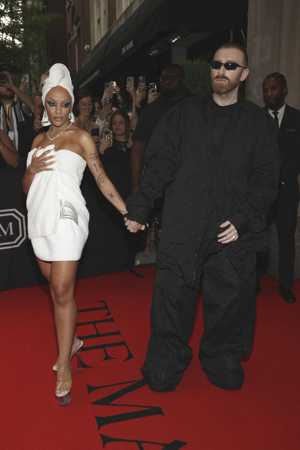 CORRECTS TO GURAM GVASALIA INSTEAD OF BEKA GVISHIANI - Doja Cat, left, and Guram Gvasalia depart The Mark Hotel prior to attending The Metropolitan Museum of Art's Costume Institute benefit gala celebrating the opening of "Sleeping Beauties: Reawakening Fashion" on Monday, May 6, 2024, in New York. (Photo by CJ Rivera/Invision/AP)