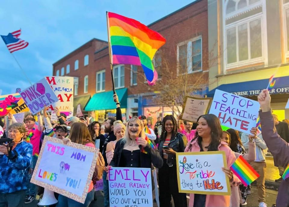 Supporters pose with signs and pride flags at Downtown Divas drag show at Sunrise Theater in Southern Pines, Dec. 3, 2022.