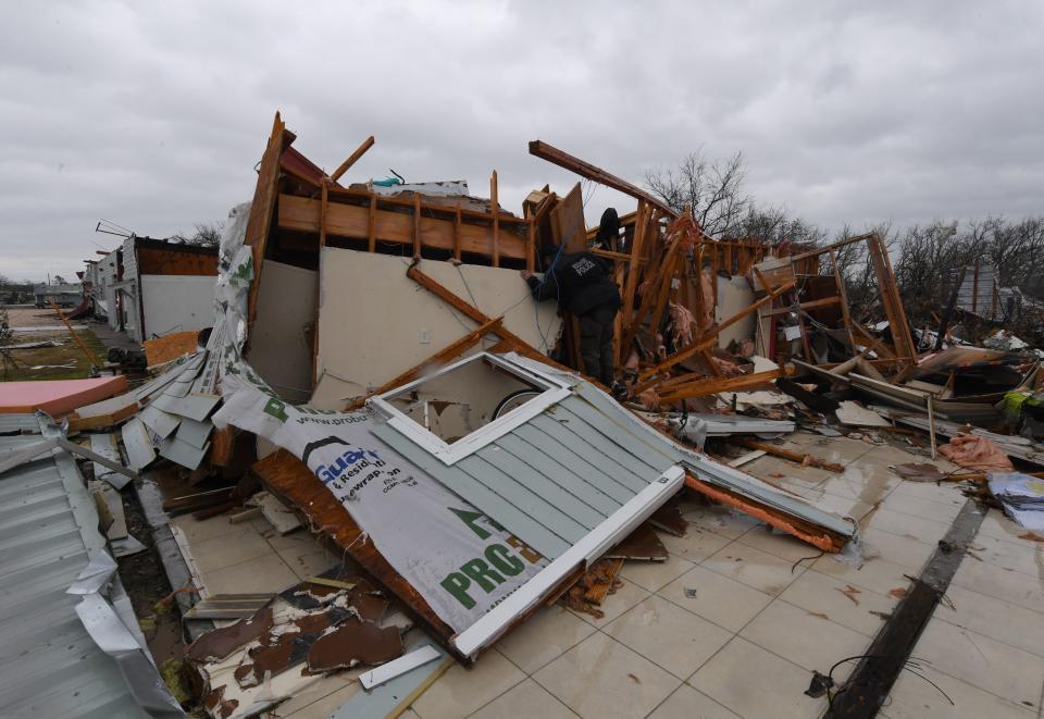 A police officer checks for survivors among destroyed houses in Rockport.