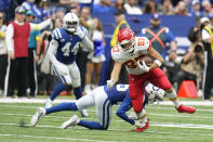 Kansas City Chiefs tight end Travis Kelce (87) is tackled by Indianapolis Colts' Rodney Thomas II (25) during the second half of an NFL football game, Sunday, Sept. 25, 2022, in Indianapolis. (AP Photo/Michael Conroy)
