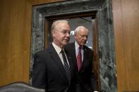 Senate Finance Committee Chairman Sen. Orrin Hatch, R-Utah, right, escorts Health and Human Services Secretary-designate, Rep. Tom Price, R-Ga. on Capitol Hill in Washington, Tuesday, Jan. 24, 2017, prior to the start of the committee's confirmation hearing for Price. Price is backed by Republicans but under fire from Democrats for his support for tearing down Obama's health care overhaul and his past stock trades. (AP Photo/Andrew Harnik)