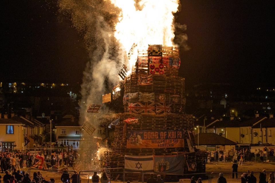 People gather at the burning of a bonfire to mark the Catholic Feast of the Assumption in the Bogside area of Londonderry (Liam McBurney/PA) (PA Wire)