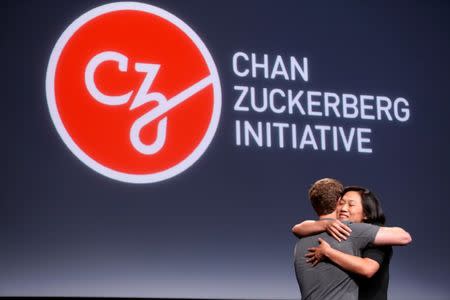 Pricilla Chan (R) embraces her husband Mark Zuckerberg while announcing the Chan Zuckerberg Initiative to "cure, prevent or manage all disease" by the end of the century during a news conference at UCSF Mission Bay in San Francisco, California, U.S. September 21, 2016. REUTERS/Beck Diefenbach