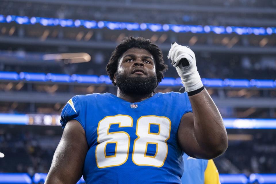 Chargers offensive lineman Jamaree Salyer gestures to the crowd.