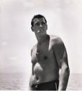 <p>Rock Hudson smokes a cigarette on the beach in 1940.</p>