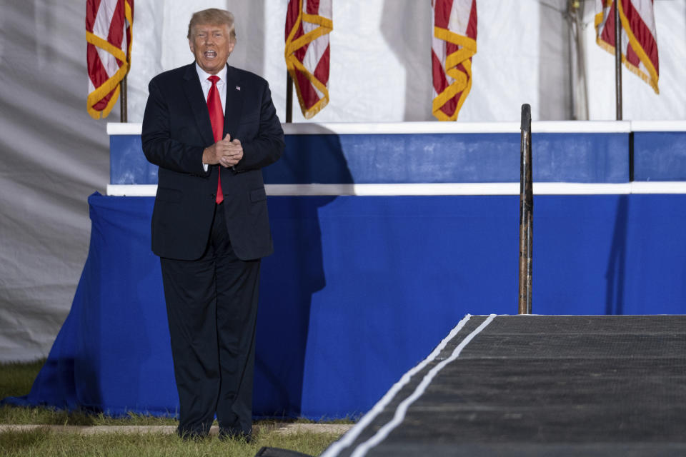 FILE - In this Saturday, Sept. 25, 2021 file photo, former President Donald Trump prepares to take the stage during his Save America rally in Perry, Ga. Supporters of Republican Georgia Gov. Brian Kemp are fighting back against Donald Trump and their own party leaders. They are angered by Trump’s Sept. 25 rally in Georgia where the former president again attacked Kemp. (AP Photo/Ben Gray, File)