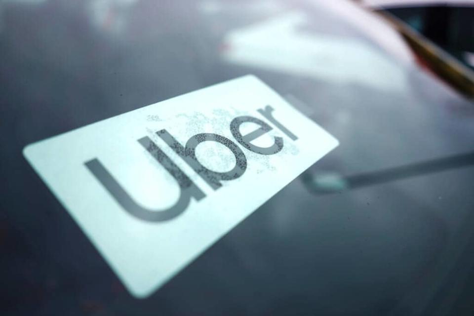 An Uber sign is displayed inside a car in Palatine, Ill., Thursday, Feb. 10, 2022. (AP Photo/Nam Y. Huh)