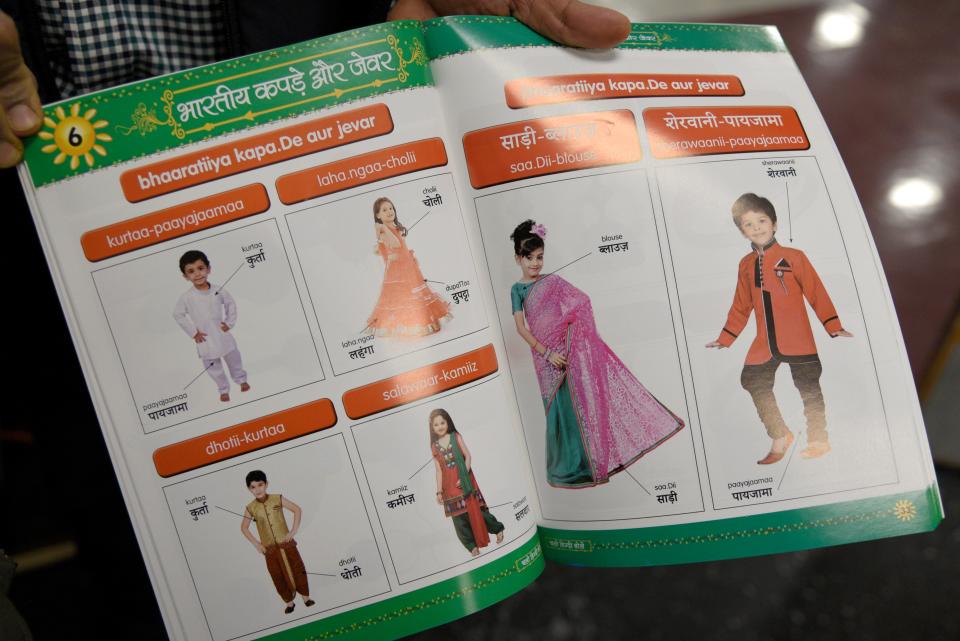 A page in the Marlboro Hindi School’s beginner’s textbook teaching students the Hindi words for traditional Indian clothes on Saturday, December 17, 2022 at Marlboro Memorial Middle School in Marlboro, New Jersey. The textbook was specially designed to include Hindi and its transliteration.