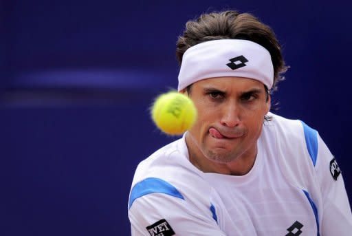 Spanish David Ferrer returns the ball to Canadian Milos Raonic during their semi-final match at the Barcelona Open tennis tournament Conde de Godo. Ferrer overcame 15 aces from Raonic to book his fourth final at the tournament with a 7-6 (7/2), 7-6 (7/5) win against the Canadian