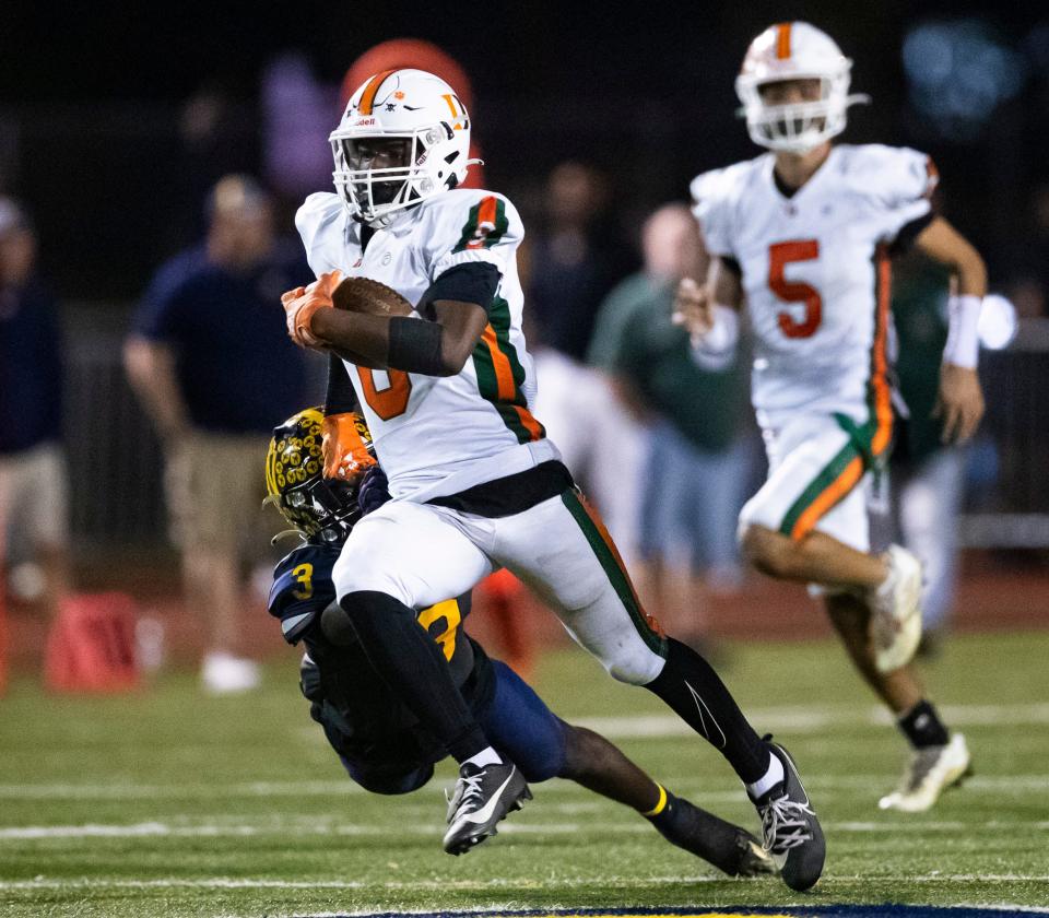 Dunbar Tigers kick returner Kelby Tyre Jr. (8) runs the ball for a game-winning touchdown during the fourth quarter of the Class 3S regional championship against the Naples Golden Eagles at Staver Field in Naples on Friday, Nov. 24, 2023.