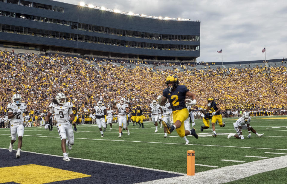 Michigan running back Blake Corum (2) leaps into the end zone for a touchdown in the first quarter of an NCAA college football game against Western Michigan in Ann Arbor, Mich., Saturday, Sept. 4, 2021. (AP Photo/Tony Ding)