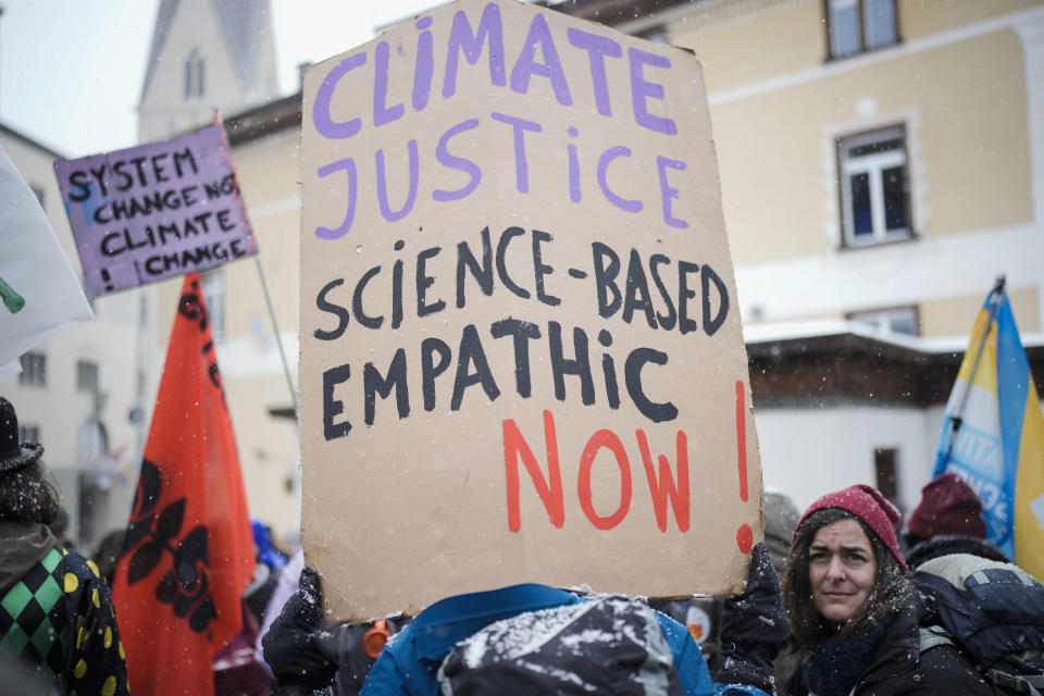 People attend a demostration demanding climate justice and against the annual meeting of the World Economic Forum in Davos, Switzerland, Sunday, Jan. 15, 2023. The annual meeting of the World Economic Forum is taking place in Davos from Jan. 16 until Jan. 20, 2023. (AP Photo/Markus Schreiber)