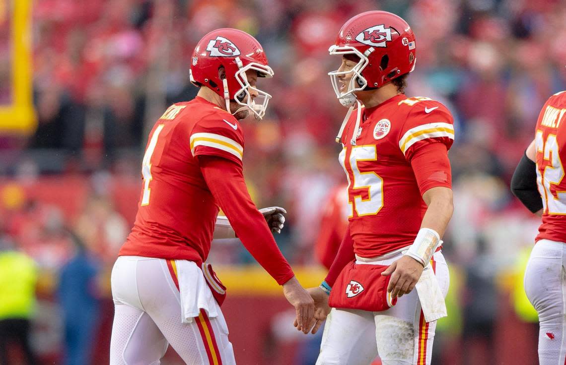 Kansas City Chiefs quarterback Patrick Mahomes (15) congratulates Kansas City Chiefs quarterback Chad Henne (4) after Henne led the Chiefs on a 98-yard touchdown drive against the Jacksonville Jaguars during an NFL divisional round playoff game at GEHA Field at Arrowhead Stadium on Saturday, Jan. 21, 2023, in Kansas City.
