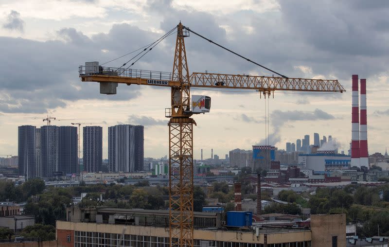 A general view of a Liebherr construction crane with city skyline in the background in Moscow