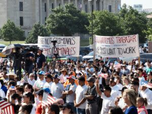  Protestors at a Hispanic Cultural Day rally hold signs outside the Oklahoma State Capitol on Wednesday to oppose the newly enacted House Bill 4156, which creates the criminal offense of impermissible occupation. (Photo by Nuria Martinez-Keel/Oklahoma Voice)