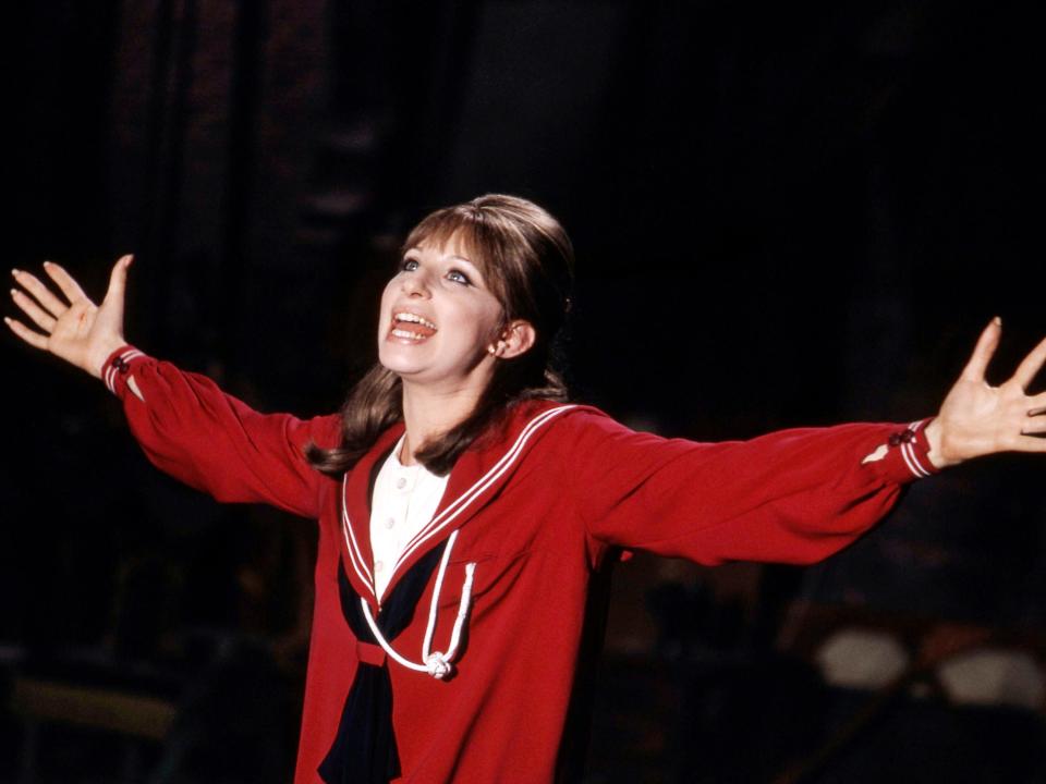 Barbara Streisand as Fanny Brice in a red coat