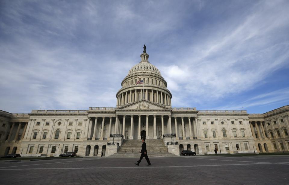 A lone worker passes by the U.S. Capitol building in Washington, October 8, 2013. A few faint glimmers of hope surfaced in the U.S. fiscal standoff, both in Congress and at the White House, with President Barack Obama saying he would accept a short-term increase in the nation's borrowing authority to avoid a default. REUTERS/Jason Reed (UNITED STATES - Tags: POLITICS TPX IMAGES OF THE DAY)