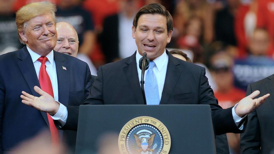 <div>SUNRISE, FLORIDA, UNITED STATES - 2019/11/26: U.S. President Donald Trump looks on as Florida Governor Ron DeSantis speaks during the Florida Homecoming rally at the BB&T Center. Trump recently became an official resident of the state of Florida. (Photo by Paul Hennessy/SOPA Images/LightRocket via Getty Images)</div>