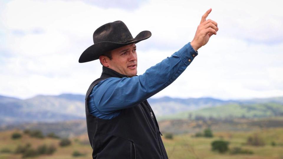 Haustin Morrison points out the boundaries of the 27,512-acre Camatta Ranch from a hilltop on April 26, 2024. The Land Conservancy of San Luis Obispo County has completed a conservation easement to preserve the property.