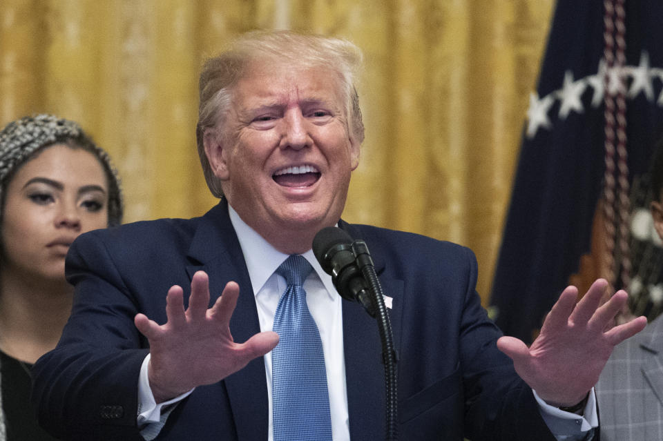 President Donald Trump speaks at the Young Black Leadership Summit 2019 in the East Room of the White House in Washington, Friday, Oct. 4, 2019. Kearyn Bolin, back left, of Texas State University listens. (AP Photo/Manuel Balce Ceneta)