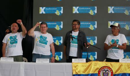 Revolutionary Armed Forces of Colombia (FARC) commander Ivan Marquez receives applause from Carlos Lozada, Pablo Catatumbo and Joaquin Gomez during a news conference at the camp where they prepare to ratify a peace deal with the Colombian government, near El Diamante in Yari Plains, Colombia, September 23, 2016. REUTERS/John Vizcaino