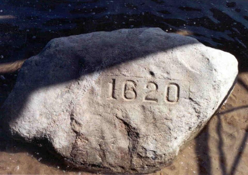 Plymouth Rock sits next to Plymouth Harbor.