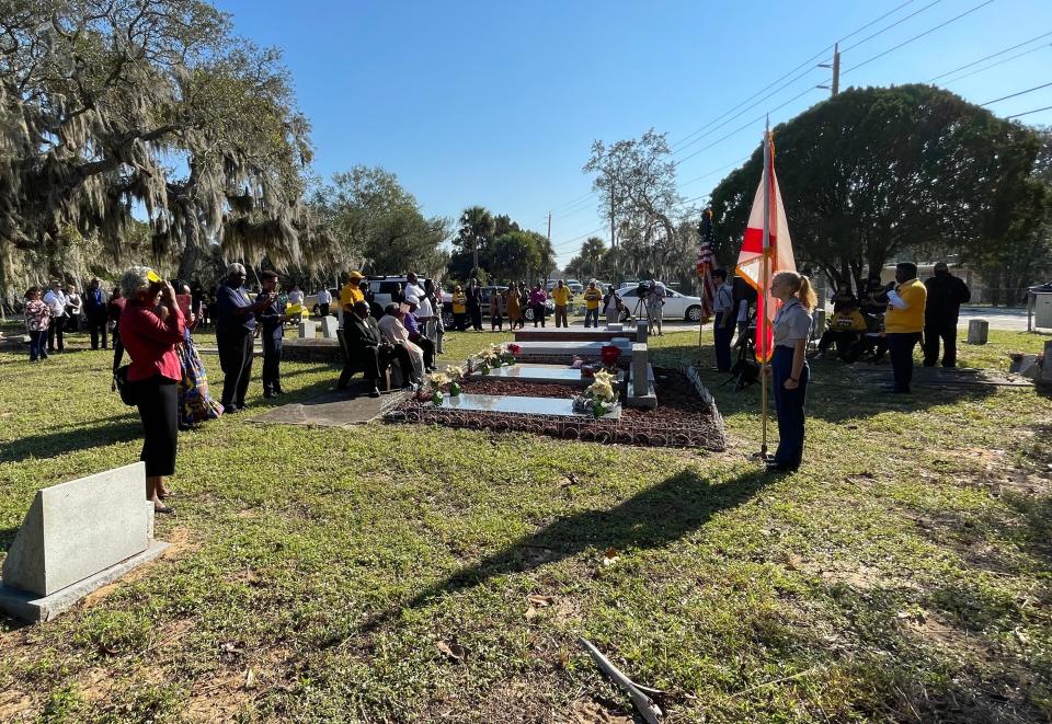 A crowd of about 40 gathered for the annual gravesite service in honor of Harry T. and Harriette V. Moore near Titusville Saturday.