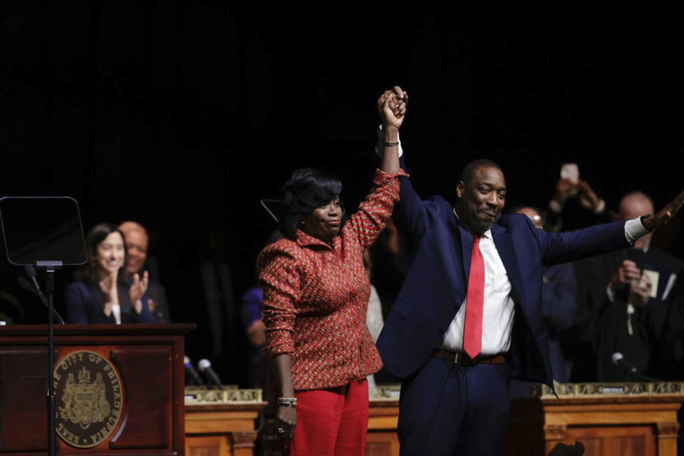 Cherelle Parker, the newly sworn-in 100th mayor of Philadelphia, left, and new Philadelphia City Council President Kenyatta Johnson, right, raise their hands together to the audience during their inauguration ceremony, Tuesday, Jan. 2, 2024, at the Met in Philadelphia. (Alejandro A. Alvarez/The Philadelphia Inquirer via AP)