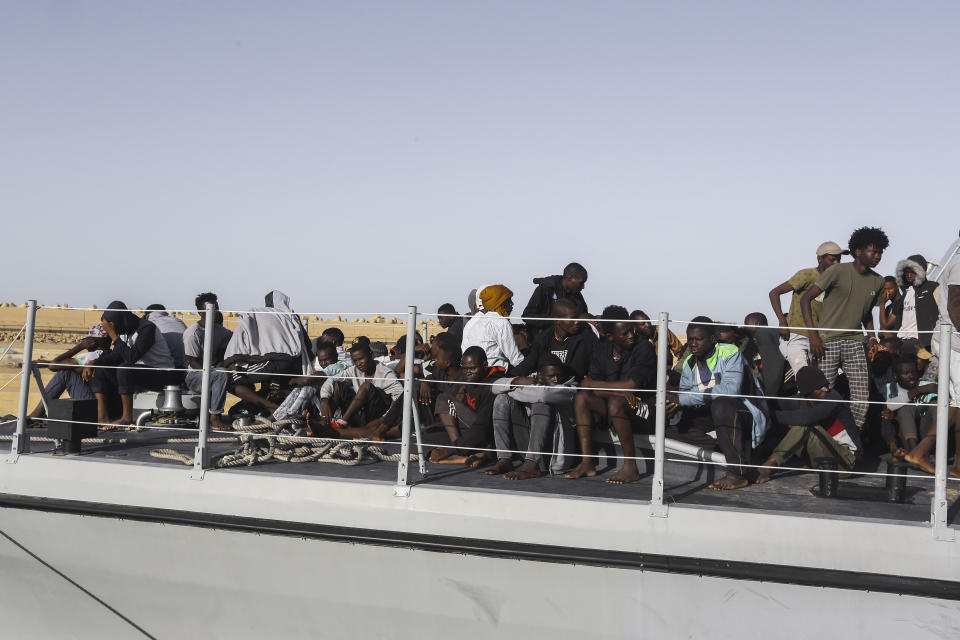 Rescued migrants sit ona coast guard boat in the city of Khoms, around 120 kilometers (75 miles) east of Tripoli, Libya, Tuesday, Oct. 1, 2019. (AP Photo/Hazem Ahmed)