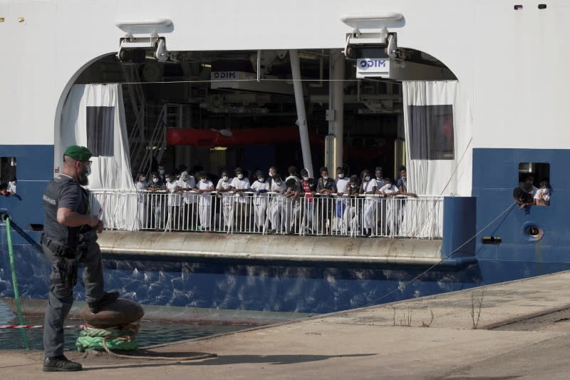 Migrants wait to disembark the ship 'Geo Barents' after week waiting at sea, in Augusta