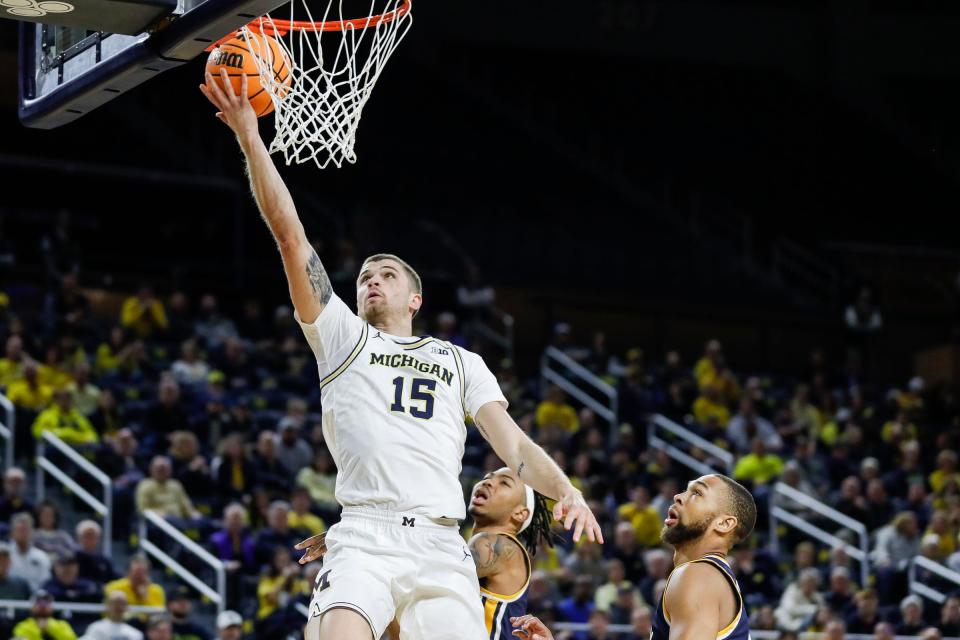 Michigan guard Joey Baker (15) makes a layup against Toledo during the first half of the first round of the NIT at Crisler Center in Ann Arbor on Tuesday, March 14, 2023.