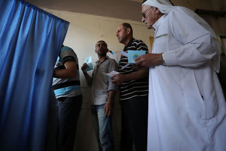 Voters queue at a polling station in Qamishli, Syria September 22, 2017. REUTERS/Rodi Said