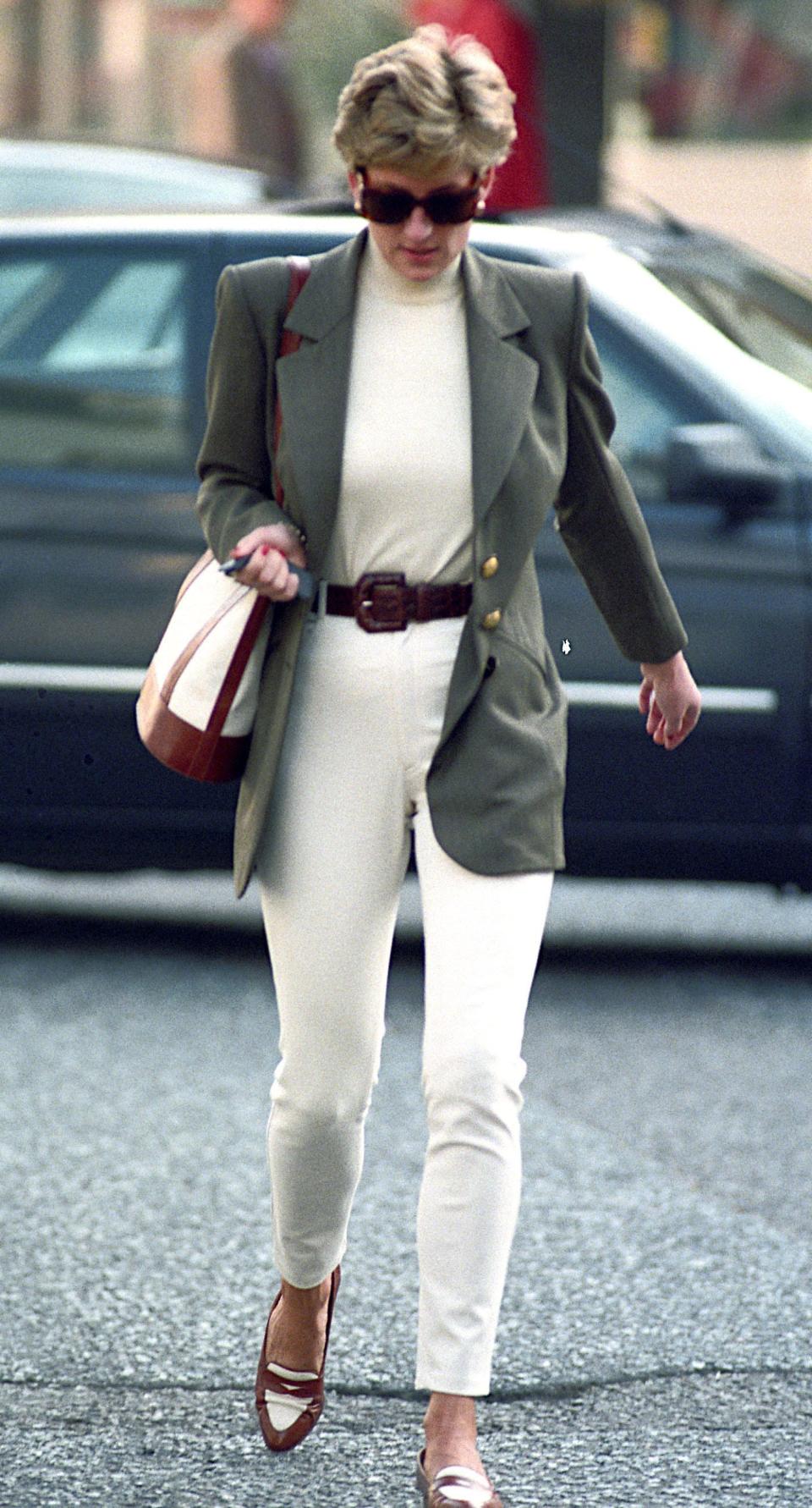 princess diana wearing a green jacket, white sweater, and white pants