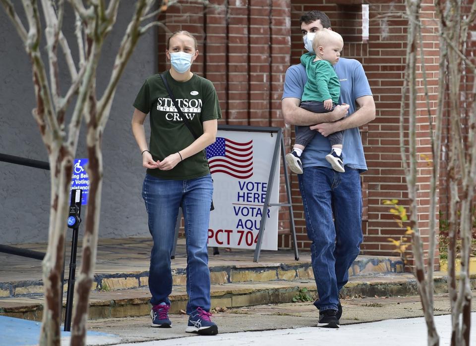 Stephanie Lengemann with husband Peter Borenstein and son Theo leave voting precinct 704 on West Sixth Street in Jacksonville's Springfield community Tuesday after voting in the special election to fill the City Council seat left open by the death of Tommy Hazouri.