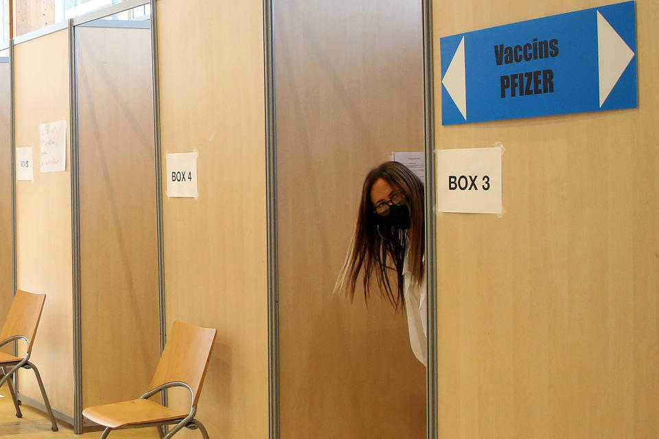A member of the medical staff waits for patients in a vaccination center in Bayonne, southwestern France, Wednesday, Nov. 10, 2021. The pandemic is again roaring across parts of Western Europe, a prosperous region with relatively high vaccination rates and good health care systems but where lockdown measures to rein in the virus are largely a thing of the past. France, also in the midst of a rise in infections, is pinning its hopes on booster shots for people already fully vaccinated while urging holdouts to get their shots. (AP Photo/Bob Edme)