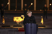 German Chancellor Angela Merkel makes a speech at the Defence Ministry during the Grand Tattoo (Grosser Zapfenstreich), a ceremonial send-off for her, in Berlin on Thursday, Dec. 2, 2021. (Odd Andersen/Pool Photo via AP)