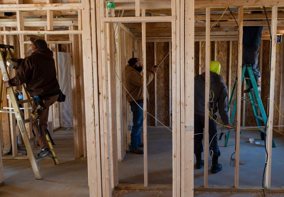 A group of contractors work inside a home being built by Hugh Stone & Sons Construction LLC at the development Canoe Creek ll in Henderson, KY., Wednesday morning, Nov. 16, 2022. Mark Stone and his brother Chris Stone have secured 20 permits to build new single family homes in Henderson since 2020. 