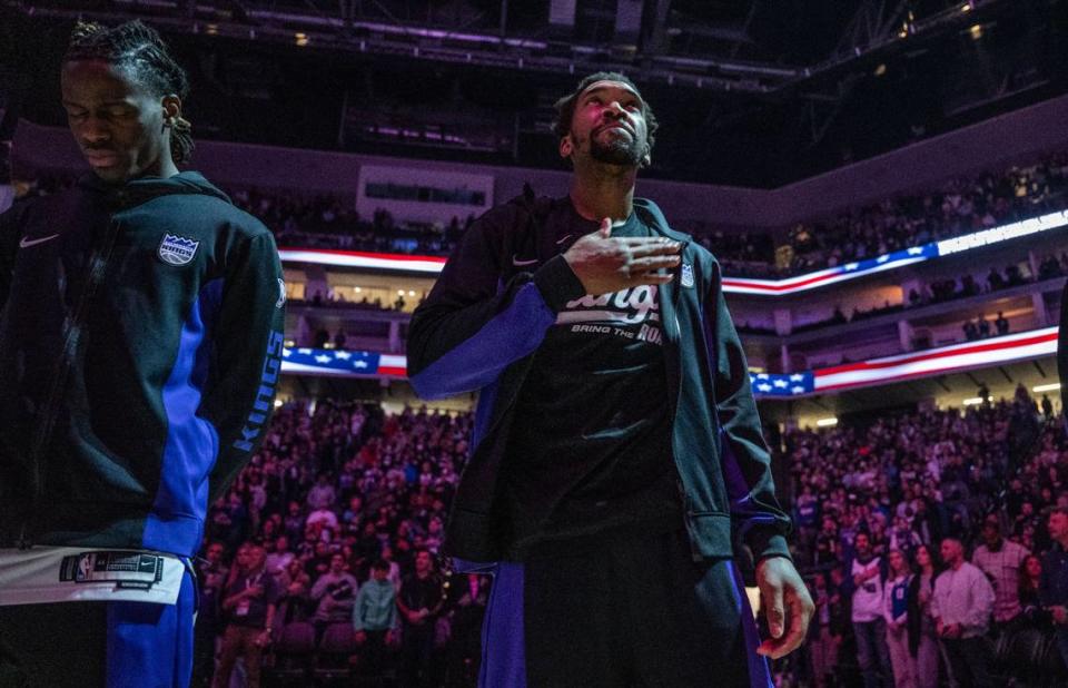 Sacramento Kings guard Malik Monk (0) taps his chest during the National Anthem before the game against the Dallas Mavericks on Friday. Monk is expected to miss 4 to 6 weeks after suffering an MCL sprain in his right knee in the first quarter. Hector Amezcua/hamezcua@sacbee.com