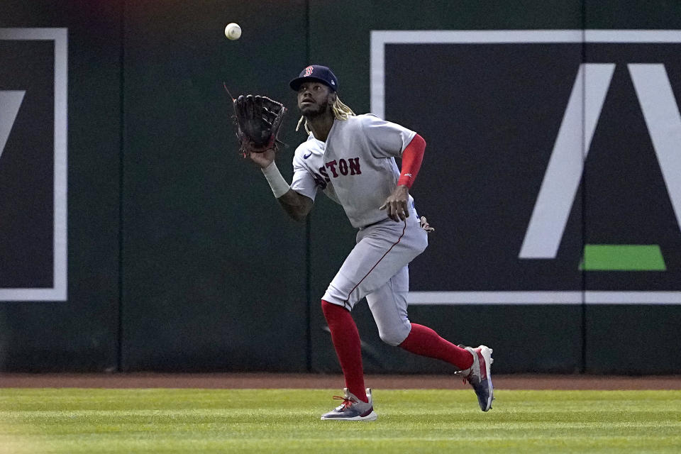 Boston Red Sox Raimel Tapia fields a fly out hit by Arizona Diamondbacks' Pavin Smith during the first inning of a baseball game, Saturday, May 27, 2023, in Phoenix. (AP Photo/Matt York)