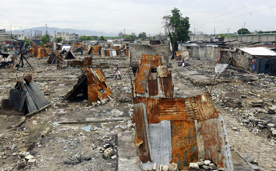 In this May 30, 2019 photo, homes that were burned to the ground during a massacre lay in ruins in the La Saline slum of Port-au-Prince, Haiti. This is where a weeklong massacre began last year on Nov. 13, when men with guns and machetes broke into homes, killing at least 21 people and raping several women. (AP Photo/Dieu Nalio Chery)