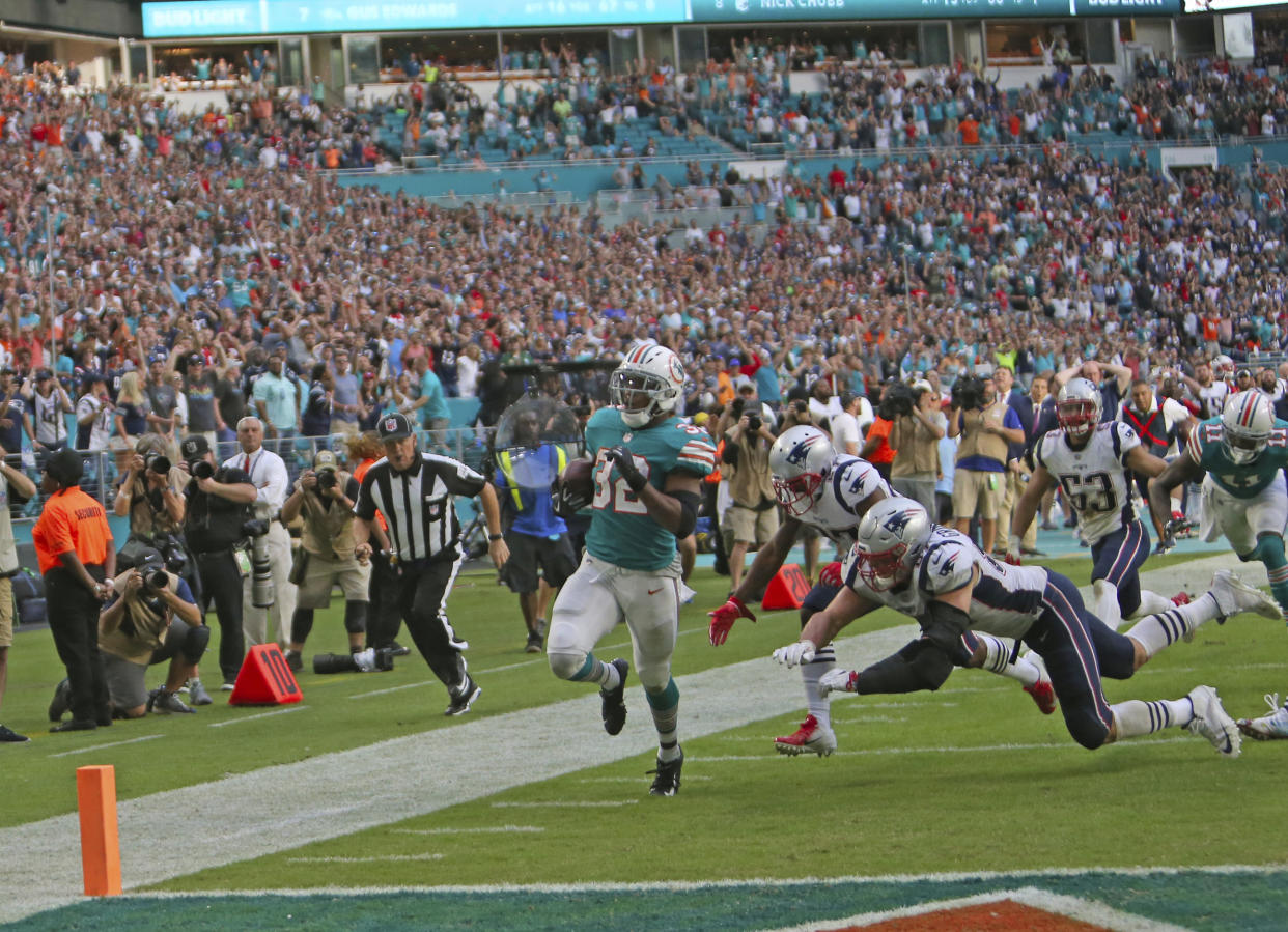Dolphins running back Kenyan Drake scores the game-winning touchdown to stun the Patriots, 34-33 on Sunday. (AP)