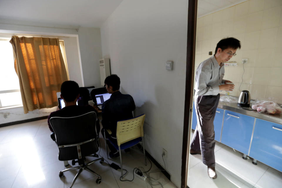 Wu Yaxiong, right, CEO of N-Wei Technology Company Ltd., fetches water at a kitchen at an apartment that he rents as an office and employees’ dormitory in Beijing on April 22, 2016. (Jason Lee/Reuters)